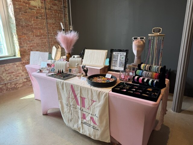 The A.Kai Adornments pop-up table dressed in soft pink linens with jewelry displays